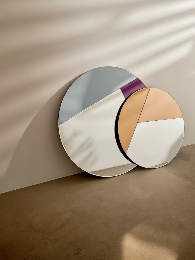 Reflections Copenhagen Nouveau mirrors, 90 and 70, with bold geometric shapes and colorful accents in an 80s-inspired geo-style.