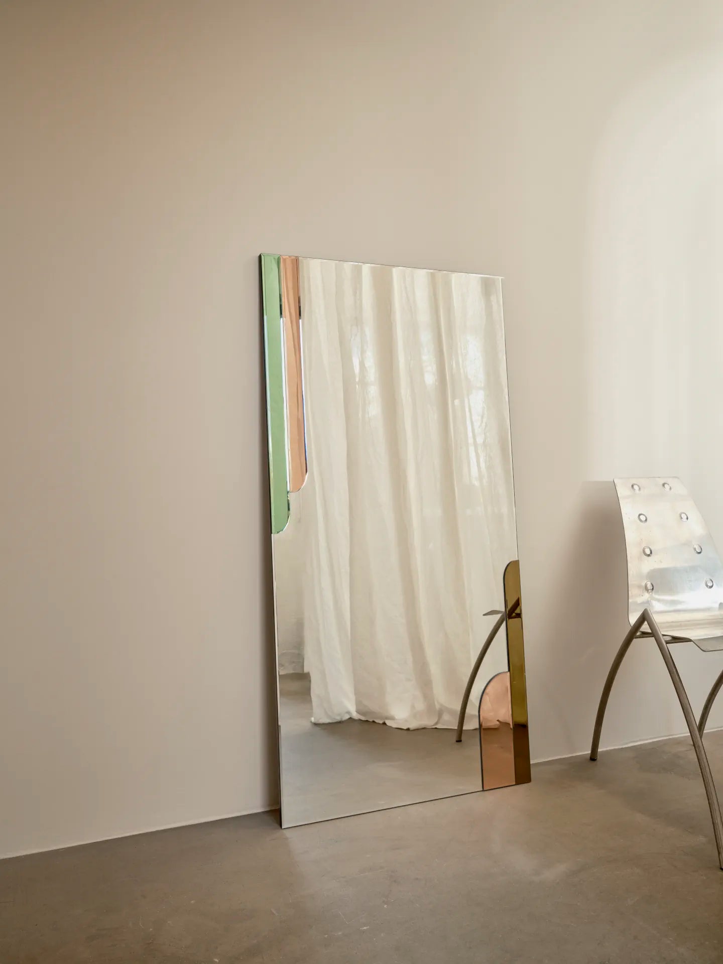 Scandinian Spring Mirror by Reflections Copenhagen, an art nouveau style full-length mirror, with hand-cut green glass accents, mounted vertically in a minimalist interior.